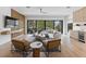 Open-concept living room with hardwood floors, modern furniture, wet bar, and a balcony at 415 N Bay Blvd, Anna Maria, FL 34216