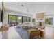 Open-concept living room with hardwood floors, modern furniture, wet bar, and a balcony at 415 N Bay Blvd, Anna Maria, FL 34216