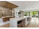Open floor plan with a kitchen island, dining area, and living room featuring modern design and natural light at 415 N Bay Blvd, Anna Maria, FL 34216