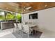 Covered outdoor dining area with a grill and built in kitchen, great for entertaining at 415 N Bay Blvd, Anna Maria, FL 34216