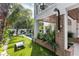 Outdoor shower with tropical landscaping, basketball court, cornhole, and putting green in backyard at 415 N Bay Blvd, Anna Maria, FL 34216
