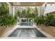 In-ground pool and hot tub surrounded by mature tropical landscaping at 415 N Bay Blvd, Anna Maria, FL 34216
