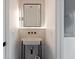 Modern powder room featuring a unique sink, stylish fixtures, and a sleek mirror at 415 N Bay Blvd, Anna Maria, FL 34216
