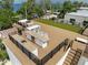 Rooftop deck with outdoor kitchen, dining, and lounging spaces with synthetic turf at 415 N Bay Blvd, Anna Maria, FL 34216