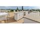 Rooftop outdoor kitchen with granite countertops, stainless steel appliances, and bar seating at 415 N Bay Blvd, Anna Maria, FL 34216