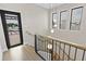 Modern stairwell featuring black railings, wood treads and three hanging lights at 415 N Bay Blvd, Anna Maria, FL 34216