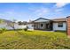 Well-maintained backyard with green grass, a white fence, and a screened-in patio attached to the house at 4107 Mulgrave Ave, North Port, FL 34287