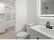 Bathroom with illuminated mirror, black hardware and fixtures, and updated toilet at 4107 Mulgrave Ave, North Port, FL 34287