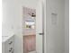 Bathroom leading into bedroom features white tiled walls and a built in niche at 4107 Mulgrave Ave, North Port, FL 34287