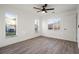 Bedroom with wood floors, neutral paint, three windows providing plenty of natural light at 4107 Mulgrave Ave, North Port, FL 34287