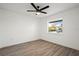 Bedroom features wood flooring, ceiling fan, and natural light from single window at 4107 Mulgrave Ave, North Port, FL 34287