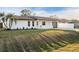 Well-manicured lawn and garden beds frame this charming single-story home with white picket fence and freshly painted exterior at 4107 Mulgrave Ave, North Port, FL 34287