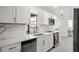 Modern kitchen features white cabinets, stainless steel appliances, and quartz countertops at 4107 Mulgrave Ave, North Port, FL 34287