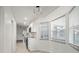 Galley kitchen featuring white cabinets, stainless appliances, tile floors, and natural lighting at 4107 Mulgrave Ave, North Port, FL 34287