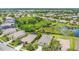 Aerial shot of a neighborhood with lush greenery, a lake, and well-kept homes in a tranquil setting at 11530 57Th Street E Cir, Parrish, FL 34219