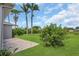 Brick patio and lush green backyard featuring tropical landscaping at 11530 57Th Street E Cir, Parrish, FL 34219