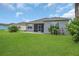 Landscaped backyard featuring green lawn and a view of neighboring houses at 11530 57Th Street E Cir, Parrish, FL 34219