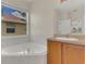 Corner bathtub with tile surround, faucet hardware and natural light at 11530 57Th Street E Cir, Parrish, FL 34219
