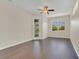 Large bedroom featuring hardwood flooring, ceiling fan, and glass door at 11530 57Th Street E Cir, Parrish, FL 34219