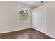 Cozy bedroom with hardwood floors, window, and a closet at 11530 57Th Street E Cir, Parrish, FL 34219