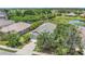 Aerial of a well-maintained single-Gathering home featuring a manicured lawn and mature trees at 11530 57Th Street E Cir, Parrish, FL 34219