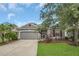 Charming single-story home featuring well-manicured lawn, mature landscaping, and a two-car garage at 11530 57Th Street E Cir, Parrish, FL 34219
