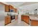 Bright kitchen featuring wood cabinets, stainless steel appliances, and tile flooring at 11530 57Th Street E Cir, Parrish, FL 34219