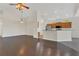 Open-concept living room with hardwood floors and views of the modern kitchen at 11530 57Th Street E Cir, Parrish, FL 34219