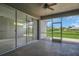 Spacious screened-in patio with ceiling fan overlooking lush landscaping and pond at 11530 57Th Street E Cir, Parrish, FL 34219