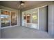 Covered patio featuring ceiling fan and access to indoor living spaces through sliding glass doors at 11530 57Th Street E Cir, Parrish, FL 34219