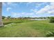 Scenic backyard view of a pond and lush landscaping in a tranquil community at 11530 57Th Street E Cir, Parrish, FL 34219