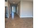 Inviting entryway with tile flooring, neutral paint, and direct access to the kitchen, hall, and front door at 345 Mangrove Manor Dr, Apollo Beach, FL 33572