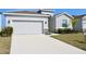 Charming single Gathering home featuring a two car garage and manicured landscaping at 345 Mangrove Manor Dr, Apollo Beach, FL 33572