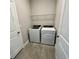 Convenient laundry room equipped with modern washer and dryer units and storage shelving at 345 Mangrove Manor Dr, Apollo Beach, FL 33572