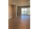 Bright living room with tile flooring and sliding glass doors that open to a picturesque lake view at 345 Mangrove Manor Dr, Apollo Beach, FL 33572
