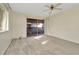 Bright bedroom featuring soft carpet, neutral walls, and sliding glass doors to a balcony at 6320 Newtown Cir # 20B1, Tampa, FL 33615