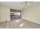 Bright bedroom featuring soft carpet, neutral walls, and sliding glass doors to a balcony at 6320 Newtown Cir # 20B1, Tampa, FL 33615