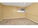 Carpeted bedroom with natural light, paint in a neutral color at 6320 Newtown Cir # 20B1, Tampa, FL 33615