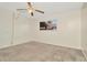 Bright bedroom features plush carpeting, a ceiling fan, and a window letting in natural light at 6320 Newtown Cir # 20B1, Tampa, FL 33615