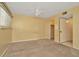 Spacious carpeted bedroom with a ceiling fan, closet, and an entrance to the bathroom at 6320 Newtown Cir # 20B1, Tampa, FL 33615
