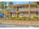 Exterior of condo complex with stairs leading to the second story balconies and walkway at 6320 Newtown Cir # 20B1, Tampa, FL 33615
