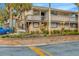 Exterior view of condo complex with landscaping and a retaining wall in front of the units at 6320 Newtown Cir # 20B1, Tampa, FL 33615