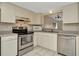 Functional kitchen with white cabinets, stainless steel appliances, and tile flooring at 6320 Newtown Cir # 20B1, Tampa, FL 33615