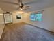 Open-concept living room features soft carpet, natural light, and a passthrough to the kitchen at 6320 Newtown Cir # 20B1, Tampa, FL 33615