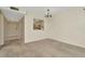 Inviting living room with neutral walls, soft carpet, and passthrough to the kitchen at 6320 Newtown Cir # 20B1, Tampa, FL 33615