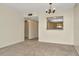 Inviting living room with neutral walls, soft carpet, and passthrough to the kitchen at 6320 Newtown Cir # 20B1, Tampa, FL 33615