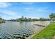 Scenic waterfront view showcasing a peaceful canal, lush greenery, and dock at 6320 Newtown Cir # 20B1, Tampa, FL 33615