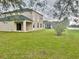Expansive backyard featuring a covered patio, lush lawn, and serene views, perfect for outdoor enjoyment at 8283 47Th Street E Cir, Palmetto, FL 34221