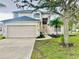 Charming two-story home with a two-car garage and well-manicured lawn, complemented by mature trees at 8283 47Th Street E Cir, Palmetto, FL 34221