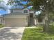 Two-story home with large garage, neutral color scheme and manicured lawn at 8283 47Th Street E Cir, Palmetto, FL 34221